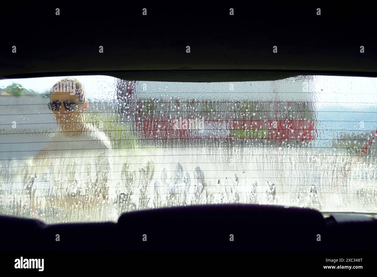 Cleaning the rear window at a manual car wash - photo from inside the ...