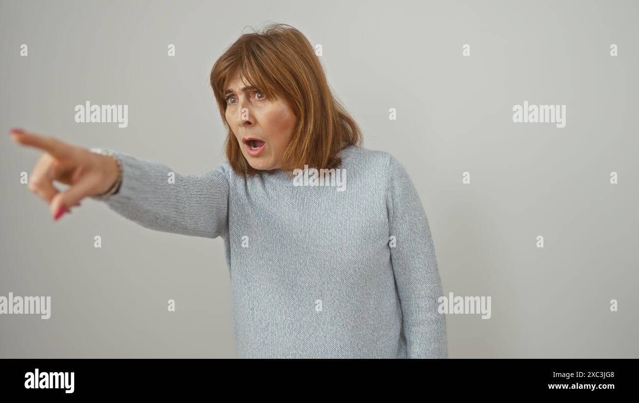 A Surprised Middle aged Woman With Short Hair Pointing And Expressing a-surprised-middle-aged-woman-with-short-hair-pointing-and-expressing