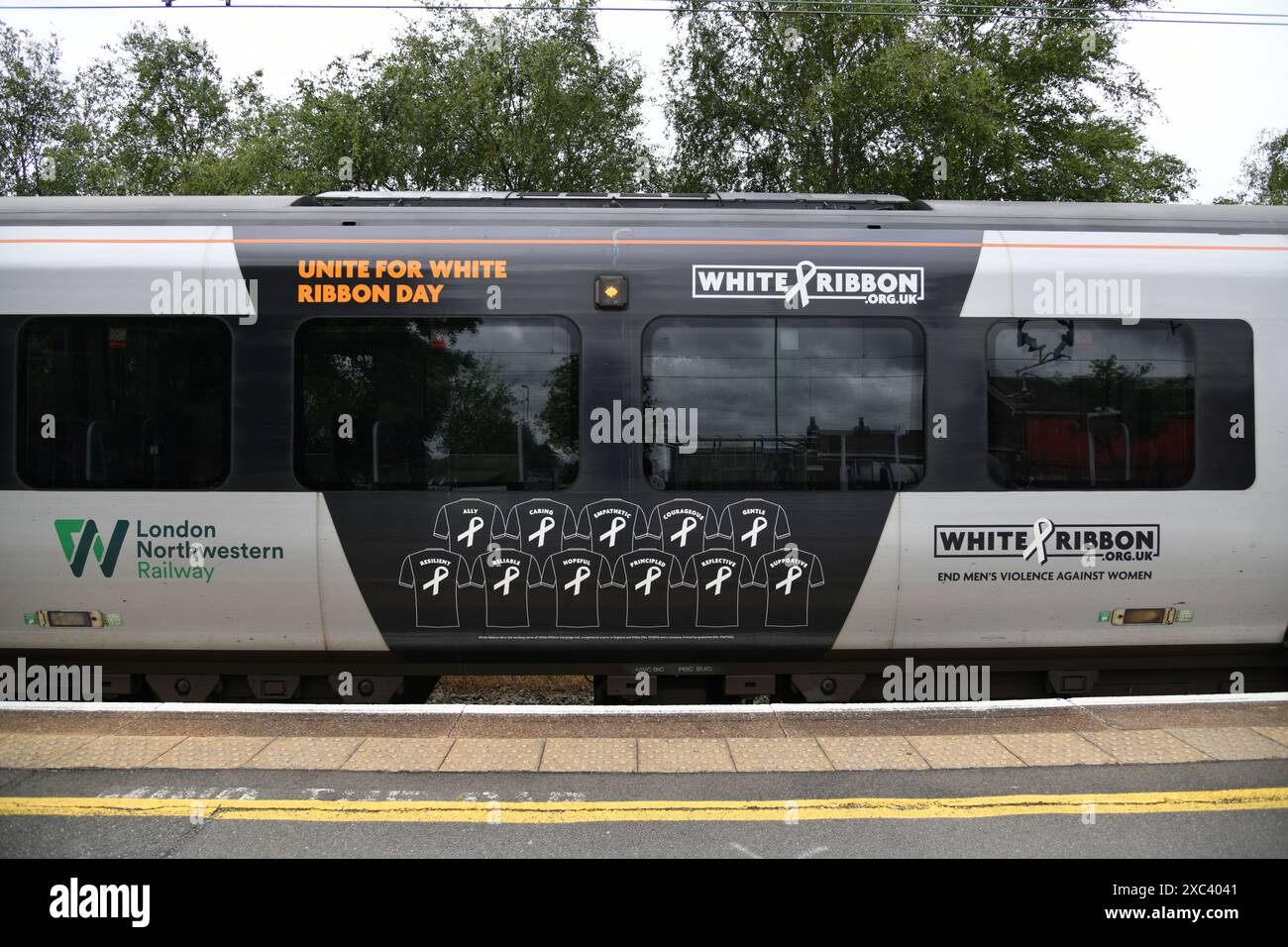 London Northwestern Railway Class 350/1 EMU number 350106 seen at Rugeley Trent Valley in advertising livery for the Charity White Ribbon Day. Stock Photo