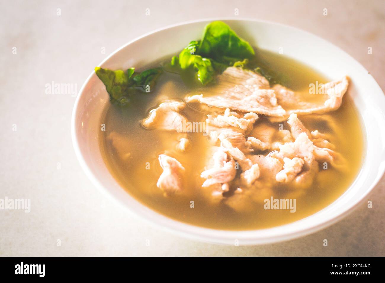 sliced lean pork with lettuce in a peppery pork soup Stock Photo