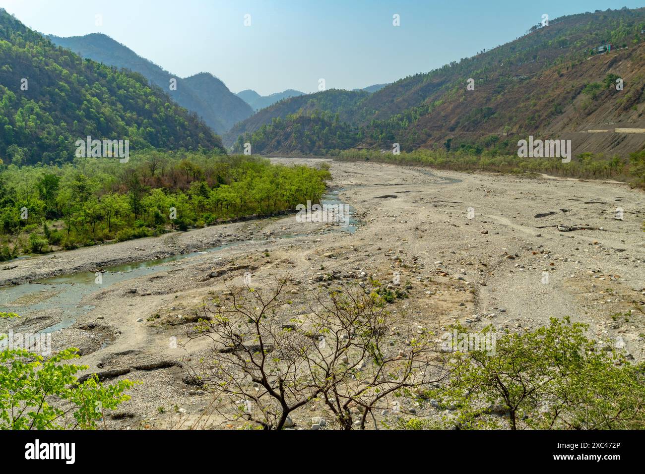 Vast Yamuna River semi-dried during summer at Maldevta region in Dehradun, Uttarakhand, with expansive valleys and mountains Stock Photo