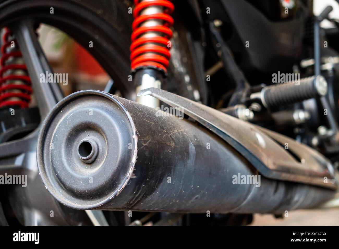 Footage of red rear shockers on motorcycle suspension. Motorbike parts. Indian motorcycle customization. Bike modification. Motorcycle engineering. Vi Stock Photo