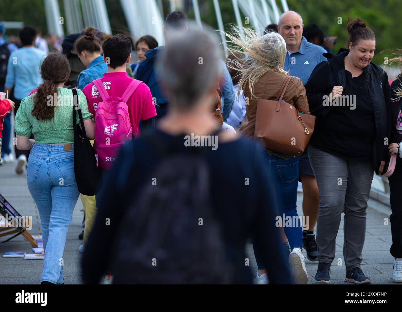 People brave strong winds in London as the Met Office has issued a yellow warning of wind. Stock Photo