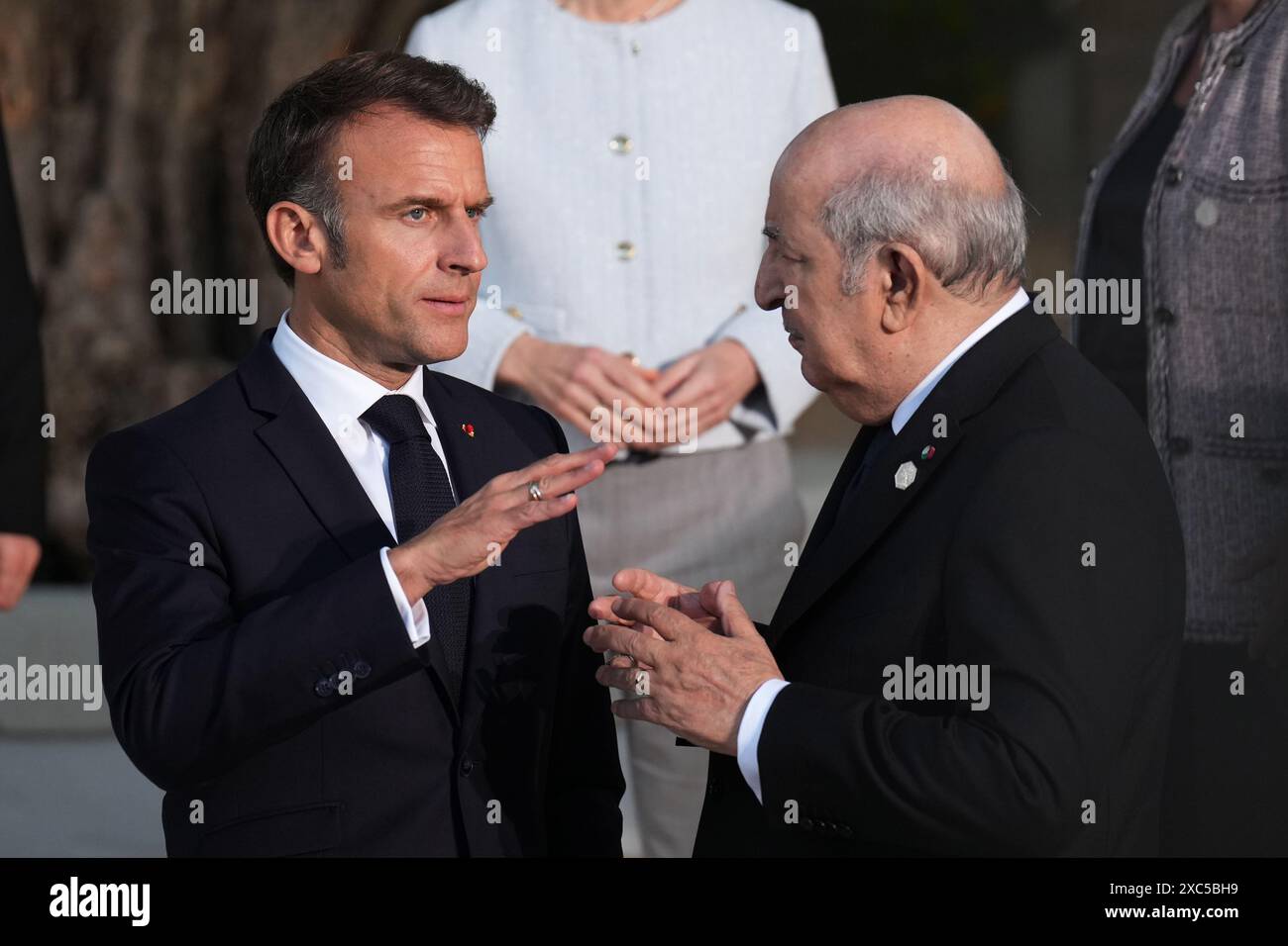 French President Emmanuel Macron chats with President of Algeria Abdelmadjid Tebboune whilst joining attending heads of state for a family photo at the G7 leaders' summit at the Borgo Egnazia resort, in Puglia, Apulia, Italy. Picture date: Friday June 14, 2024. Stock Photo