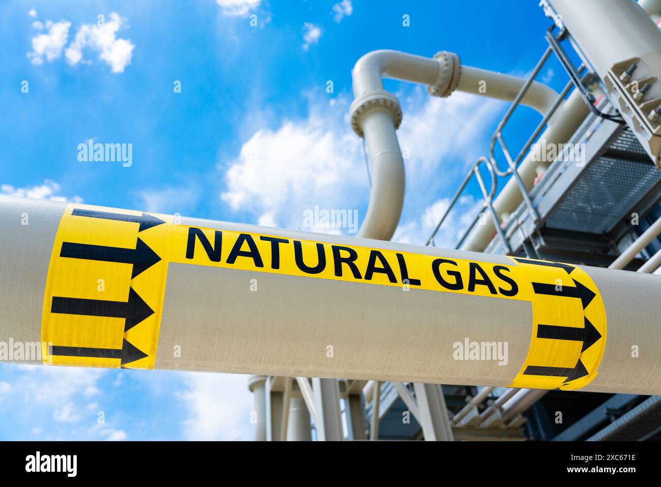 High pressure gas pipeline with flow direction sign at compressor station. Concept of industrial