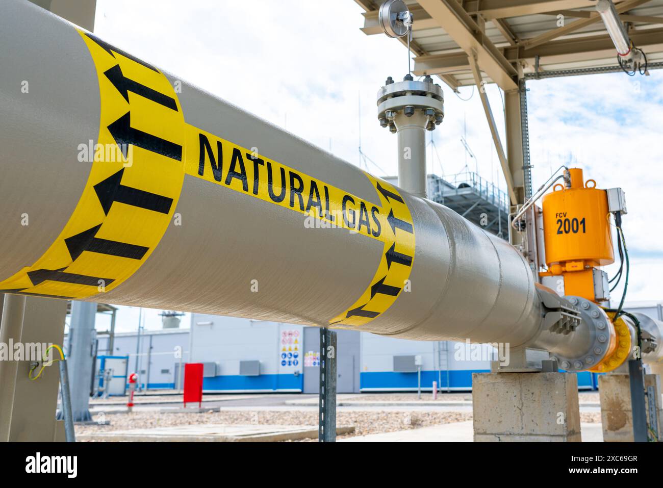 High pressure natural gas pipeline with direction sign at compressor ...