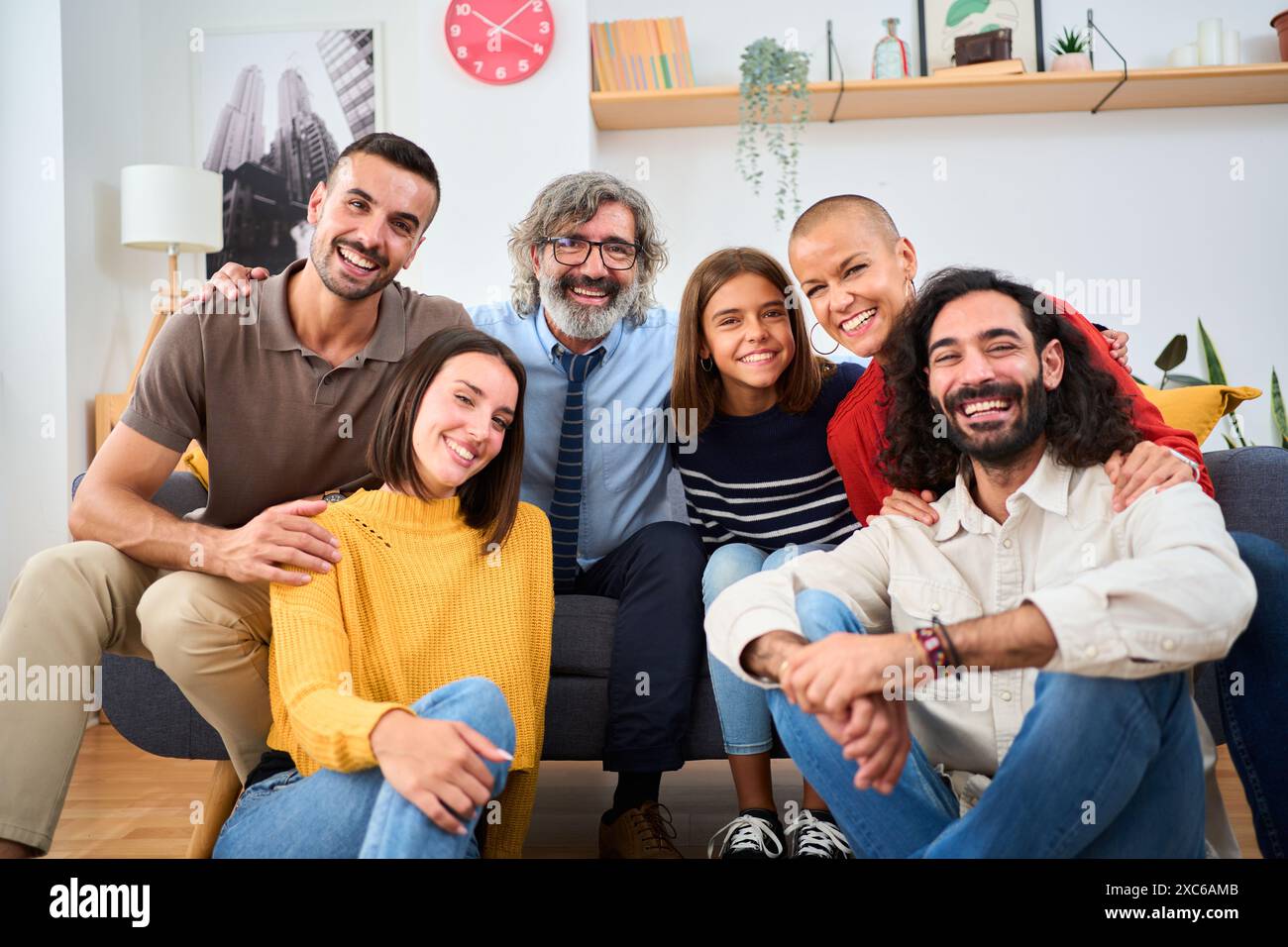 Family sitting together on sofa hi-res stock photography and images - Alamy