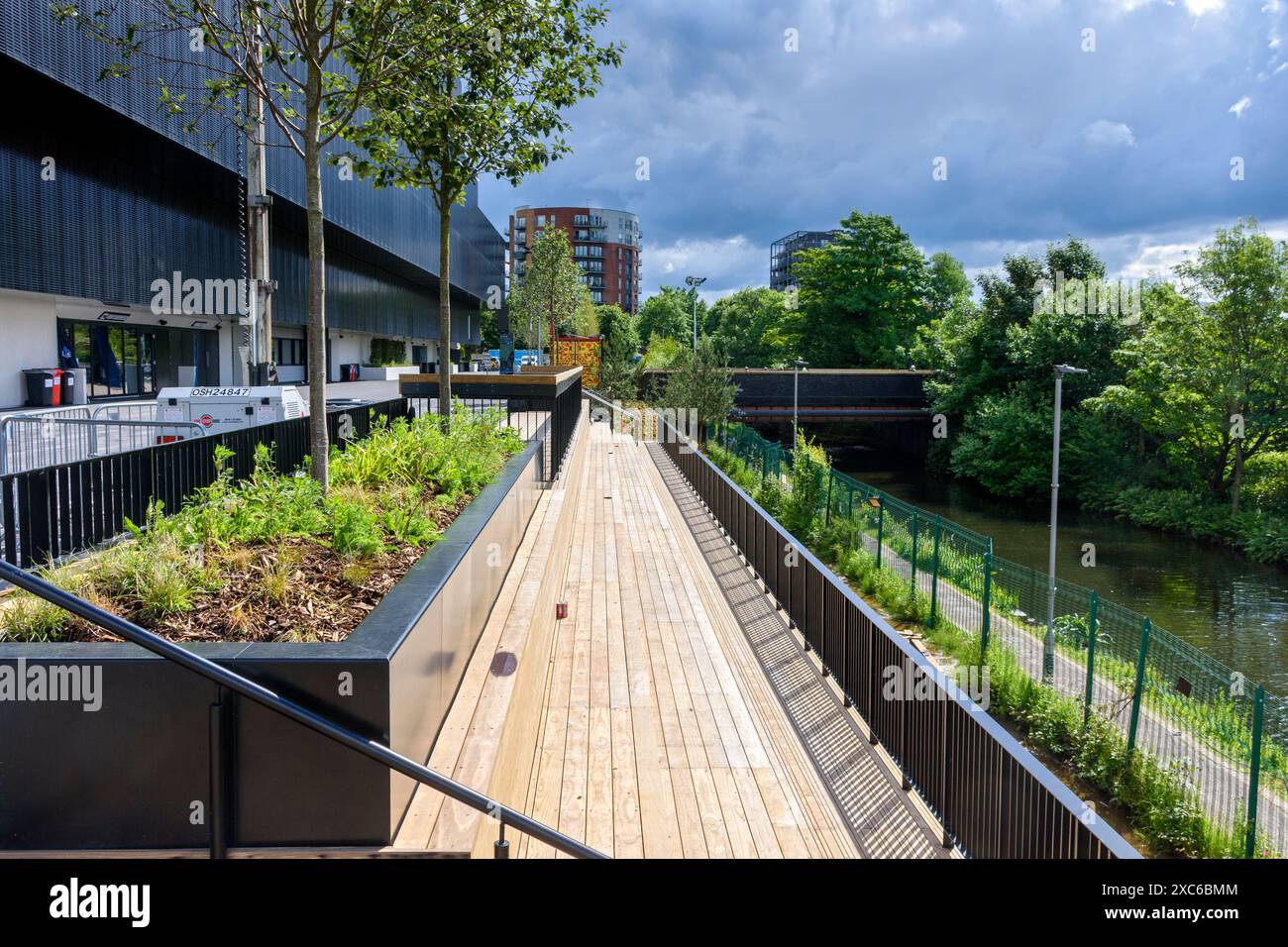 Outside seating terraces above the Ashton Canal at the Co-op Live Arena, Manchester, England, UK Stock Photo