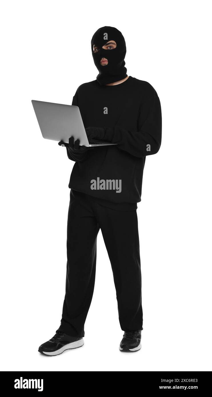 Thief in balaclava with laptop on white background Stock Photo - Alamy