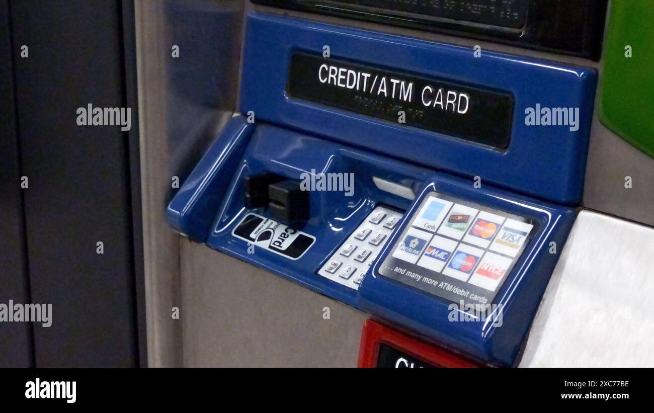 Blue ATM card reader with a slot for inserting a card and a numeric keypad for entering a PIN New York NY USA 2023-07-30 Stock Photo