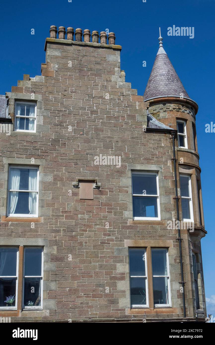 Historic stone house with a pointed roof and several windows against a clear blue sky, lerwick, shetlands, Scotland, United Kingdom Stock Photo