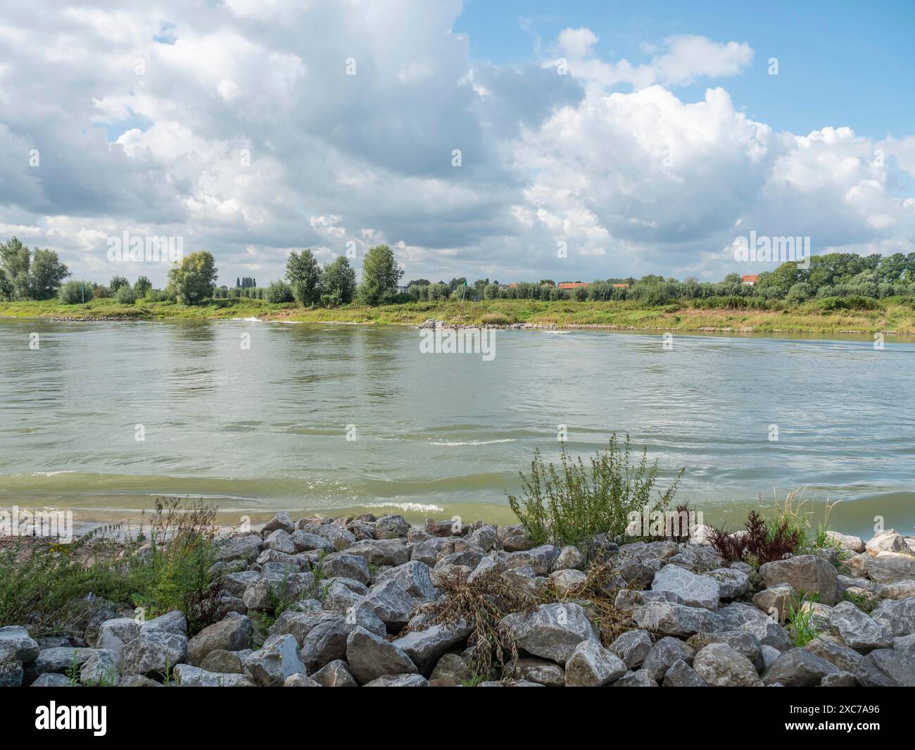 River Surrounded By Rocks River landscape with clear water, surrounded by rocks, grassy banks and ...