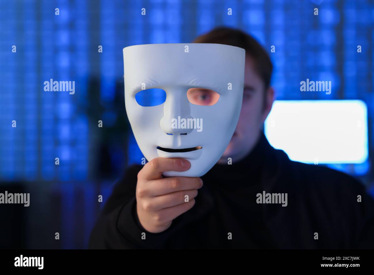 Hacker with mask in dark room, closeup Stock Photo