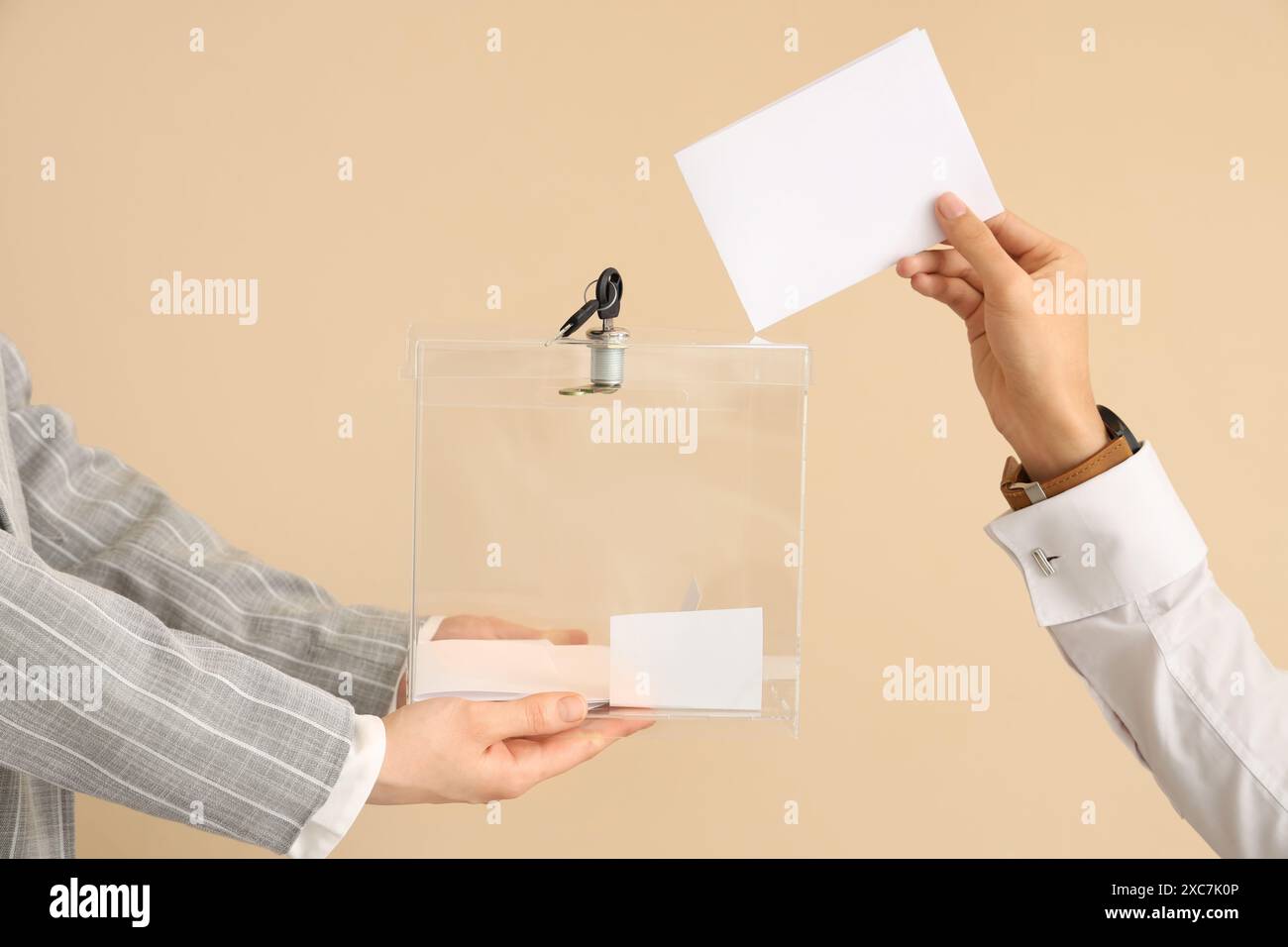 Hand putting voting paper into ballot box on beige background. Election ...