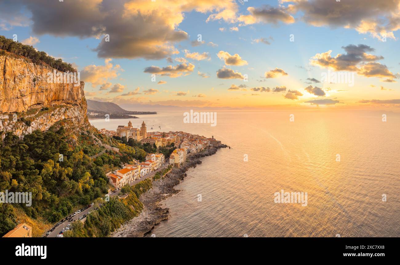 Aerial view showcasing its historic architecture, stunning coastline, and Mediterranean charm of Cefalu at sunset, Sicily. Stock Photo