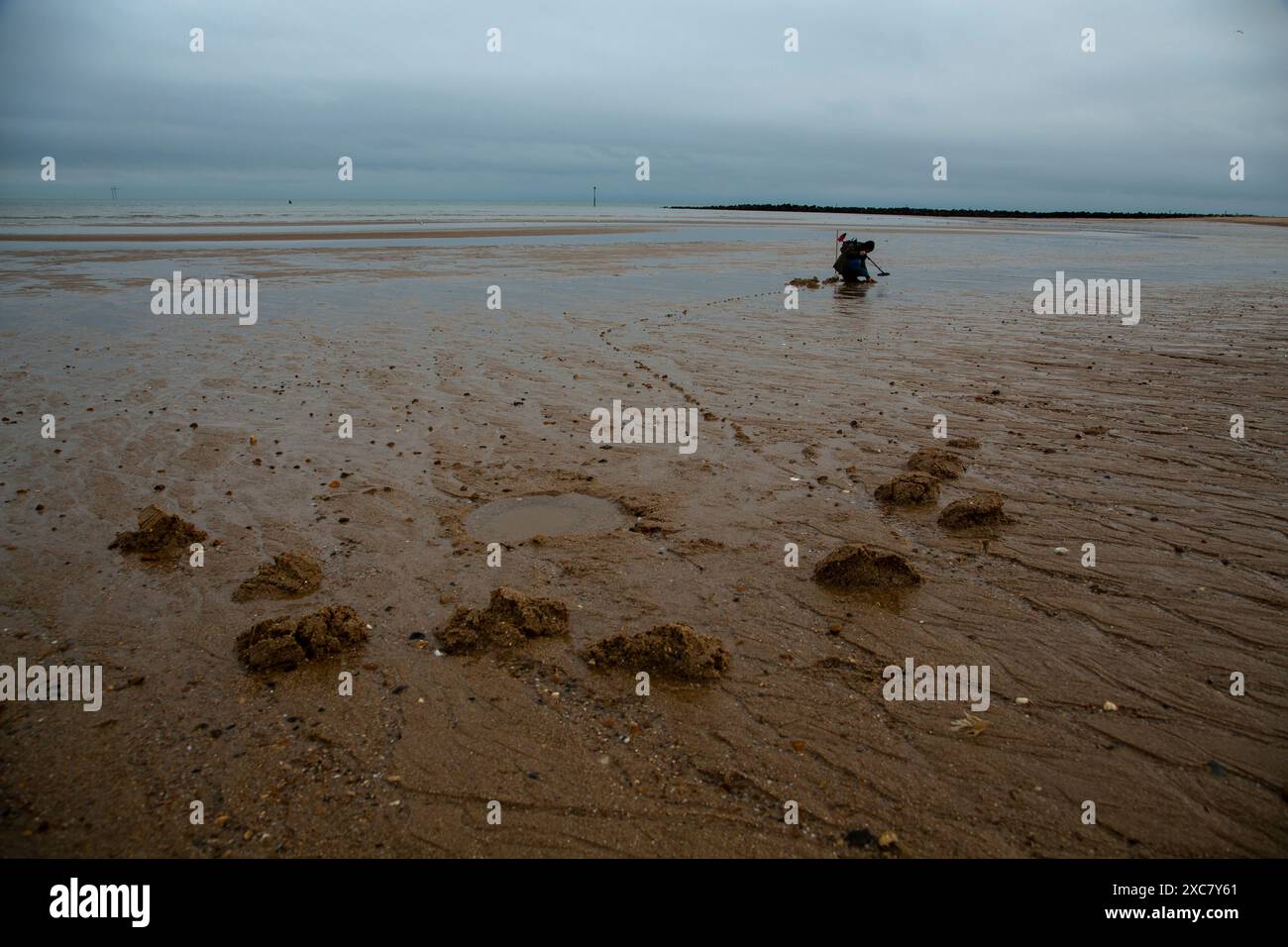 A distant figure (unidentifable) figure on Clacton-on-Sea beach ...