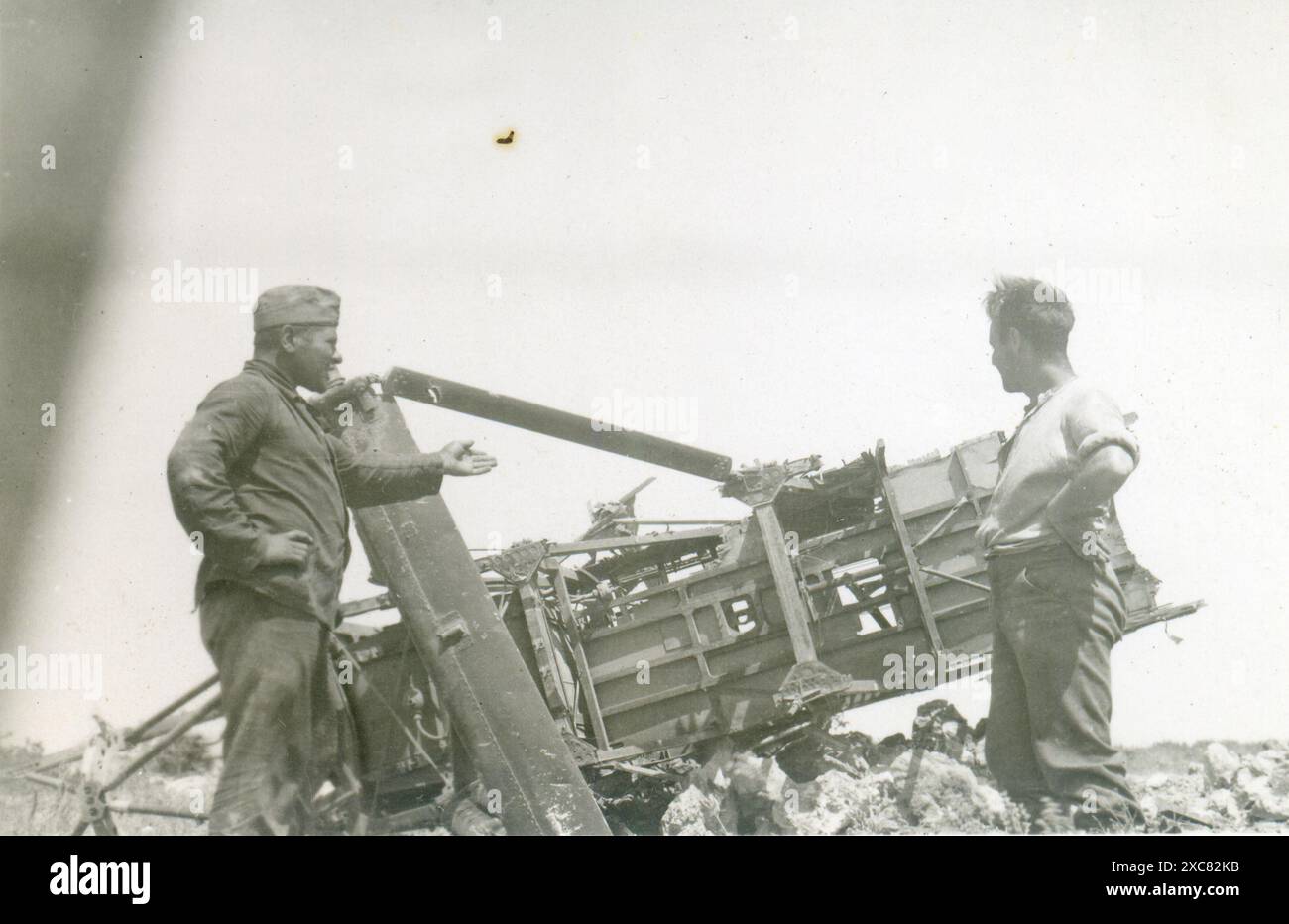 Two German soldiers examining a destroyed plane, IIWW Stock Photo - Alamy