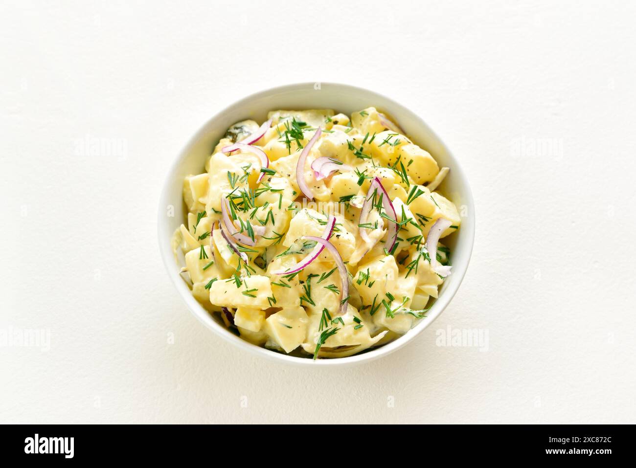 Potato salad with egg, pickle, red onion with mayonnaise and yogurt