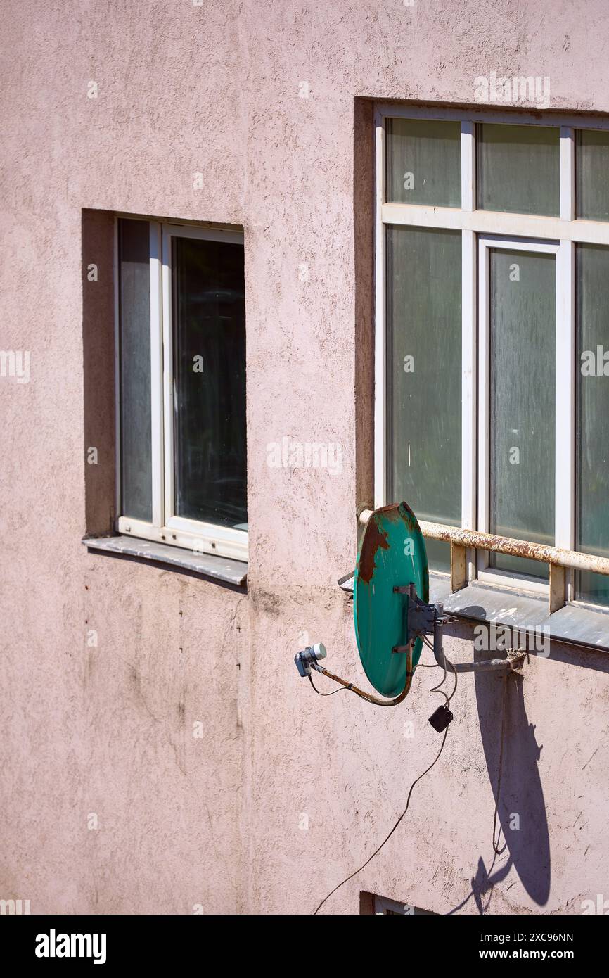 Rusty Abandoned Satellite Dish, damaged connection concept, verical Stock Photo