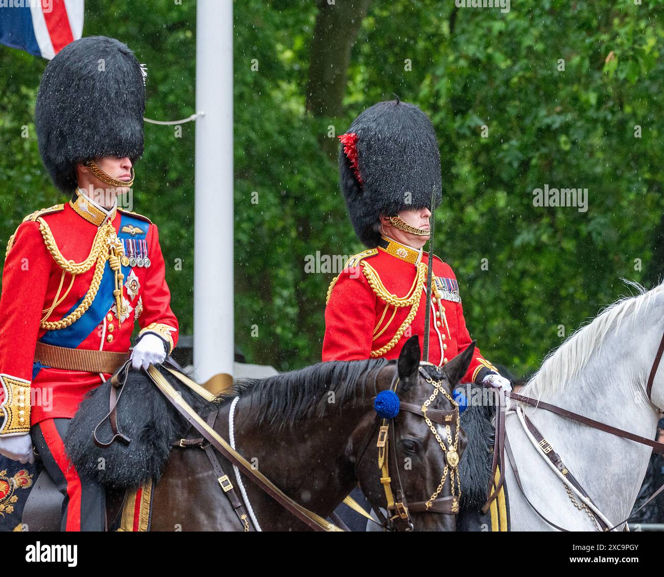 London, UK 15th Jun 2024.  Prince William, Prince of Wales returns to Buckingham Palace on horseback through heavy rain, following the Trooping the Colour ceremony. Trooping the Colour takes place each year to celebrate the monarch's official birthday. This year it was the turn of the Irish Guards to troop their colour. The procession, to and from Horse Guards Parade passes along the Mall. Credit: MartinJPalmer/Alamy Live News Stock Photo