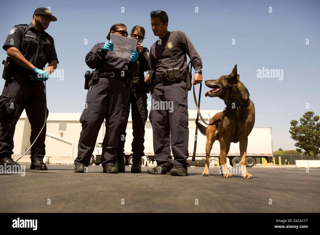 U.S. Customs and Border Protection officers prepare to inspect a ...