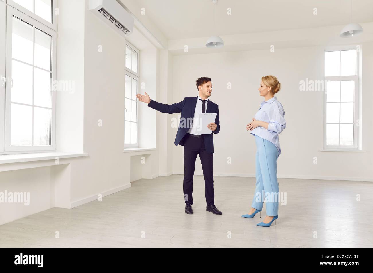 Male Realtor Showing New Home To Client Stock Photo - Alamy