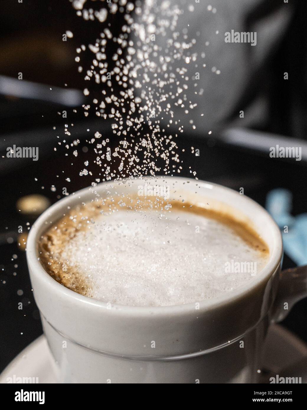 adding sugar to bitter coffee Stock Photo