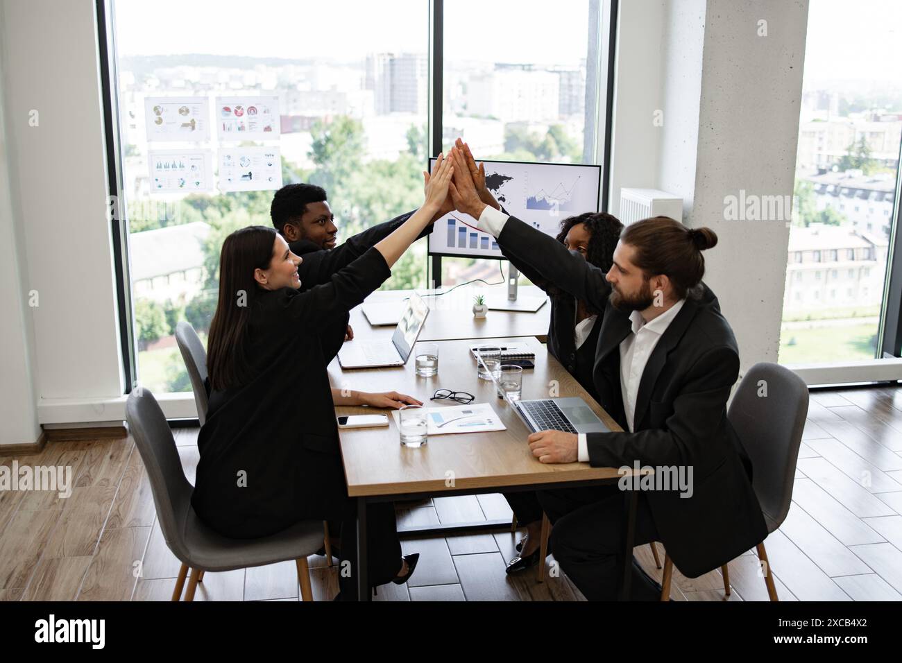 Office employees high five celebrating hi-res stock photography and ...