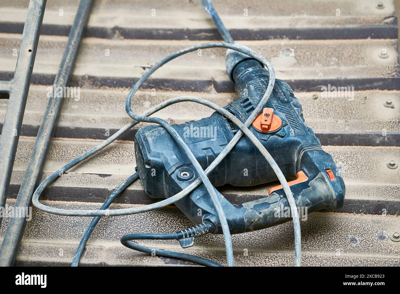 Electric rotary hammer drill on metal surface.Construction Stock Photo