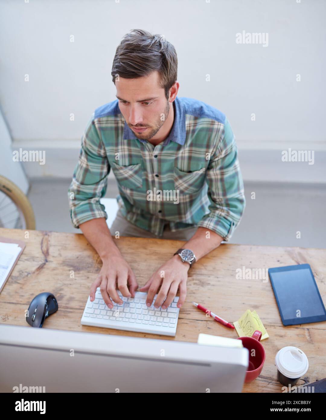 Startup, top view or man on computer for information technology, problem solving or online firewall. Technician, cybersecurity upgrade or web Stock Photo