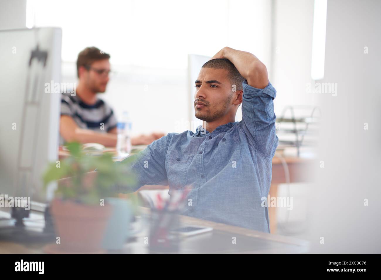 Doubt, thinking or man on computer in startup for information technology, problem solving or online firewall. Creative technician, programming or Stock Photo