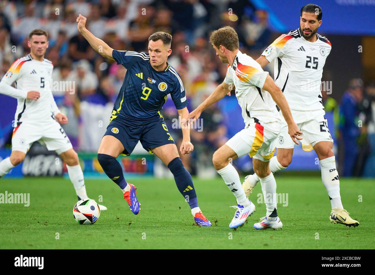 Thomas Müller, Mueller, DFB 13 Emre Can, DFB 25  compete for the ball, tackling, duel, header, zweikampf, action, fight against Lawrence Shankland, SCO 9  in the group stage match GERMANY  - SCOTLAND 5-1 of the UEFA European Championships 2024  on Jun 14, 2024  in Munich, Germany.  Photographer: Peter Schatz Stock Photo