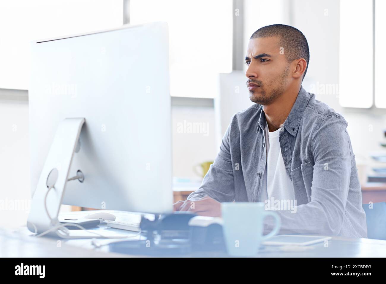 Confused, doubt or man on computer for problem solving, error solution or troubleshooting online. Startup, cybersecurity glitch or serious web Stock Photo