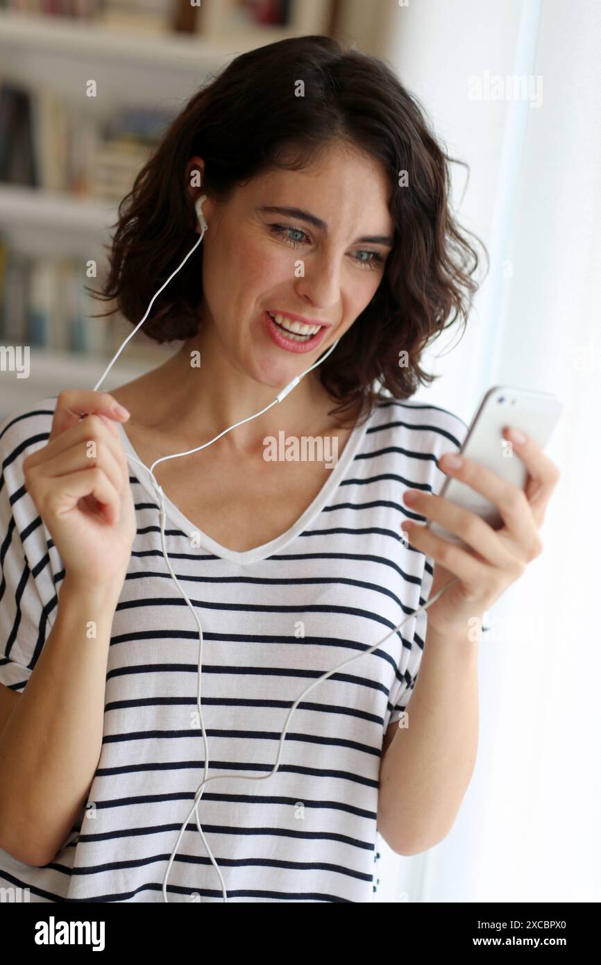 Woman listening music with Smartphone Stock Photo