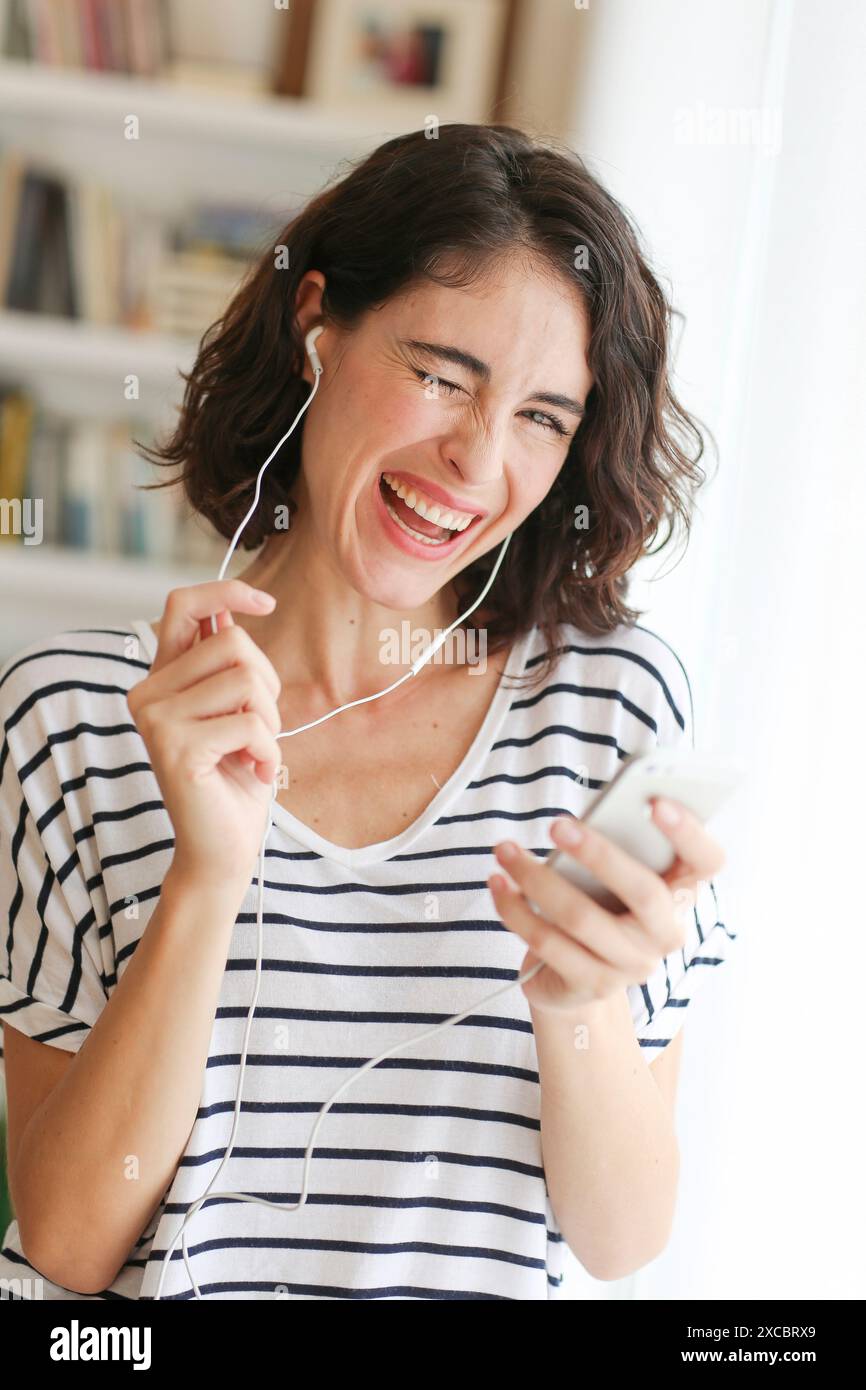 Woman listening music with Smartphone Stock Photo