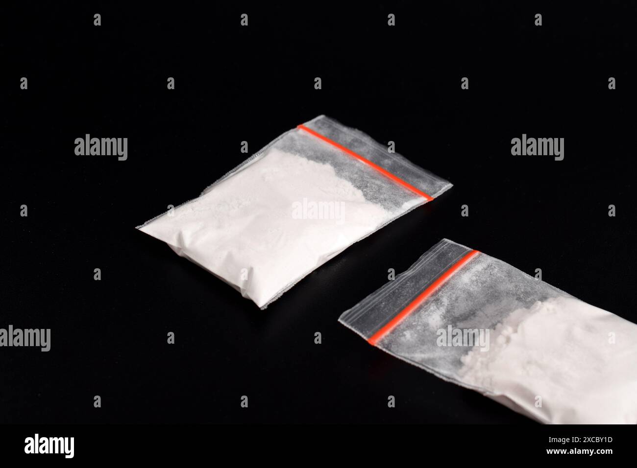 Cocaine in plastic packet isolated on black background. illustration of illegal drug substances, narcotics Stock Photo