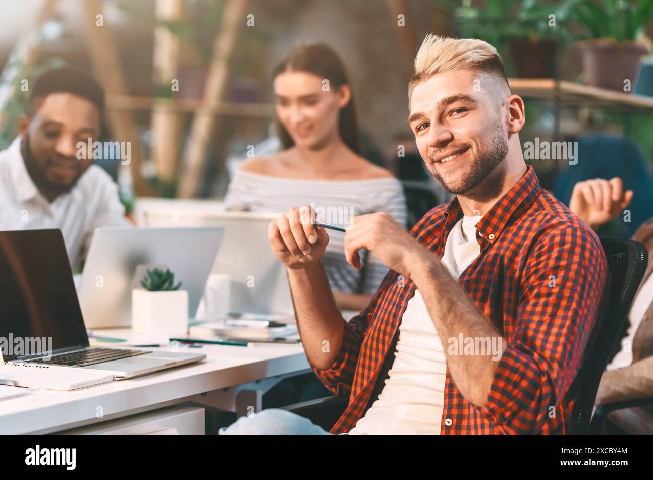 Diverse Team Collaborating in Modern Office During Daytime Stock Photo