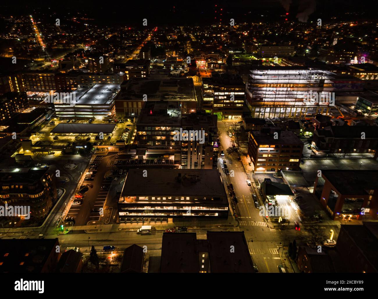 An Aerial view of a cityscape at night with illuminated buildings ...