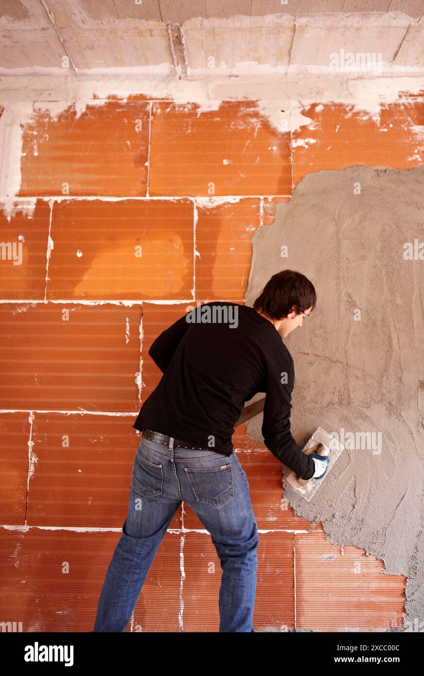 Bricklayer, rendering a partition wall, new homes under construction, construction site Stock Photo