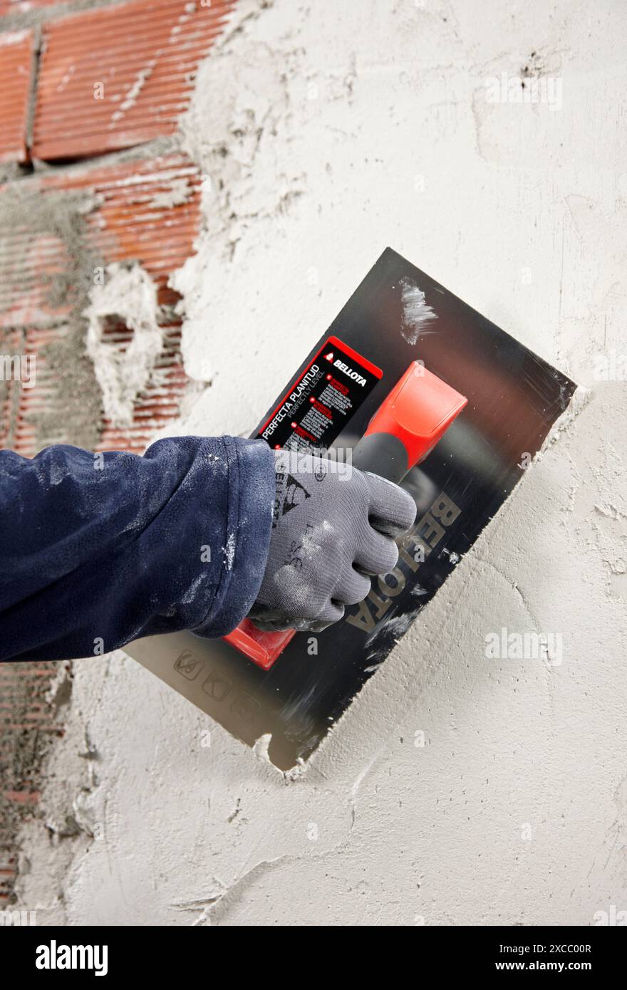 Rendering a brick wall using trowel, new homes under construction, construction site Stock Photo