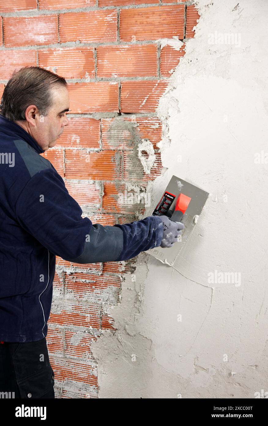 Rendering a brick wall using trowel, new homes under construction, construction site Stock Photo