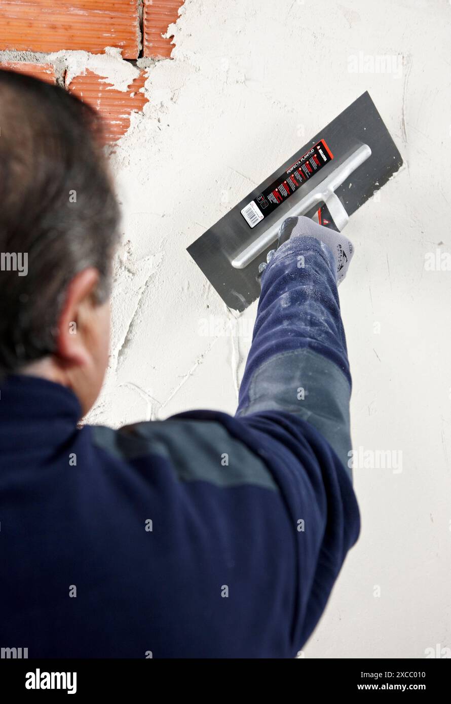 Rendering a brick wall using trowel, new homes under construction, construction site Stock Photo