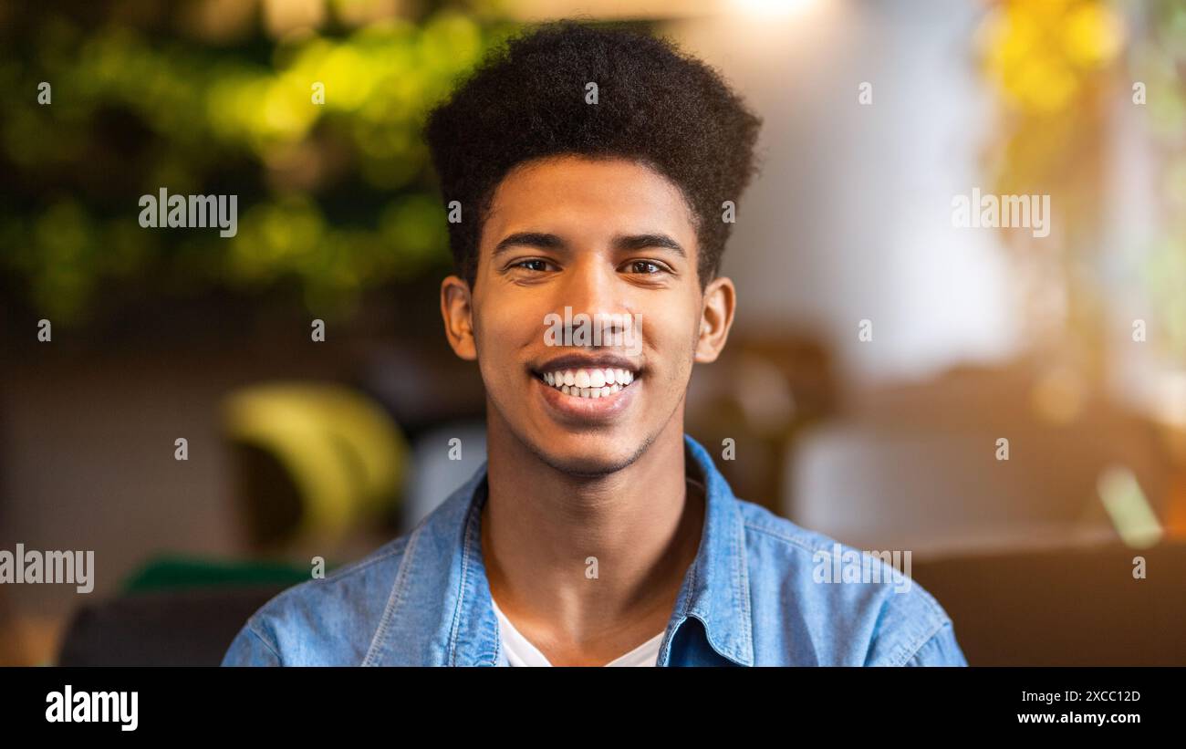 Young Black Guy Smiling in Denim Shirt Stock Photo