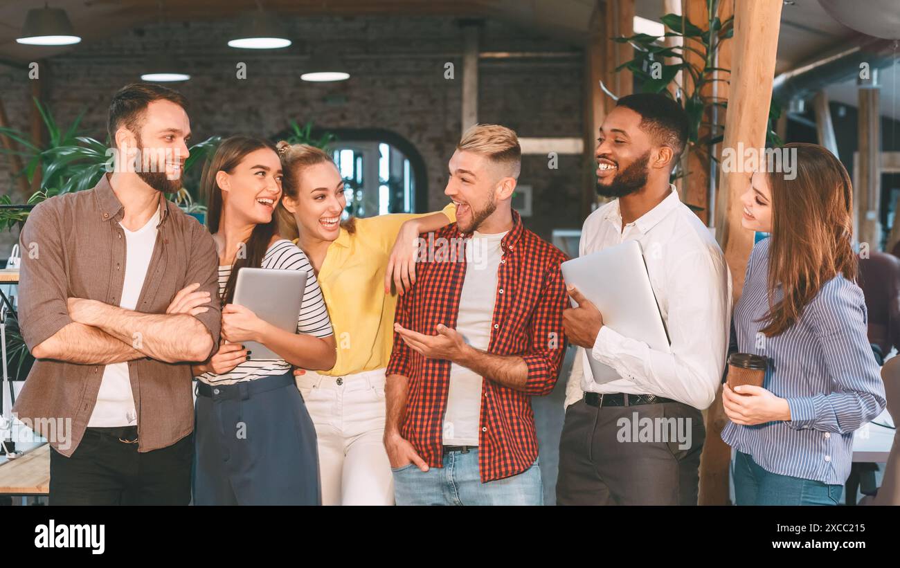 Successful workers having break, talking and laughing Stock Photo