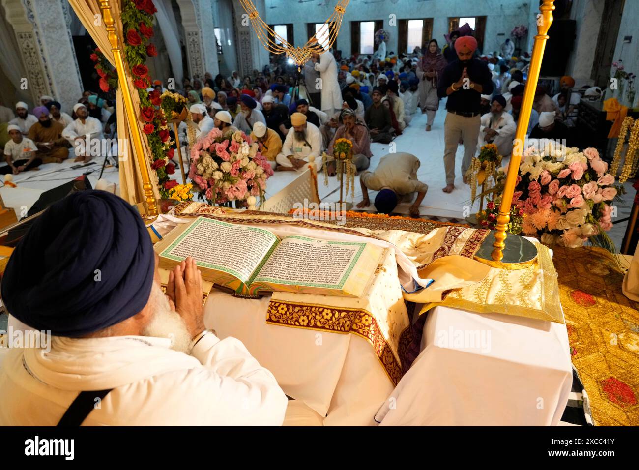 Sikh pilgrims perform rituals during a ceremony to observe the ...