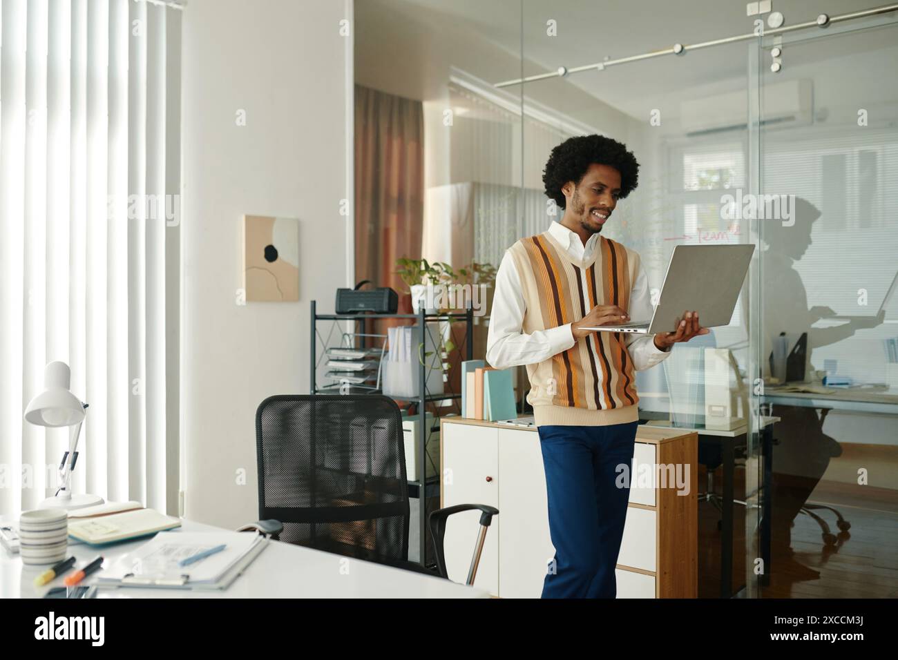 Developer working on laptop in company office Stock Photo