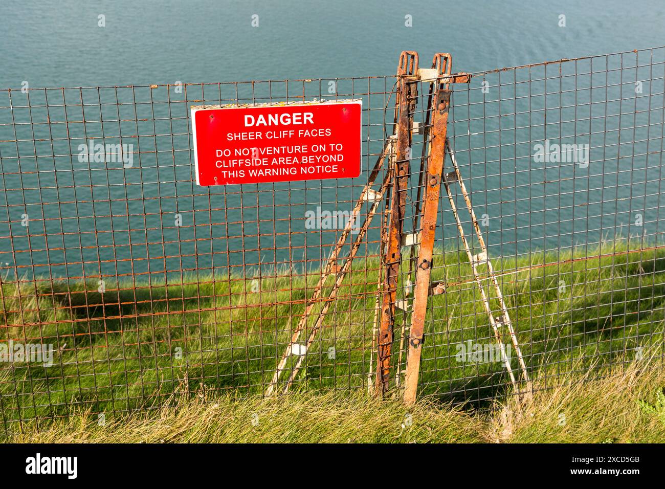 Danger sheer cliff face warning notice, Needles. Isle of Wight, England, UK Stock Photo