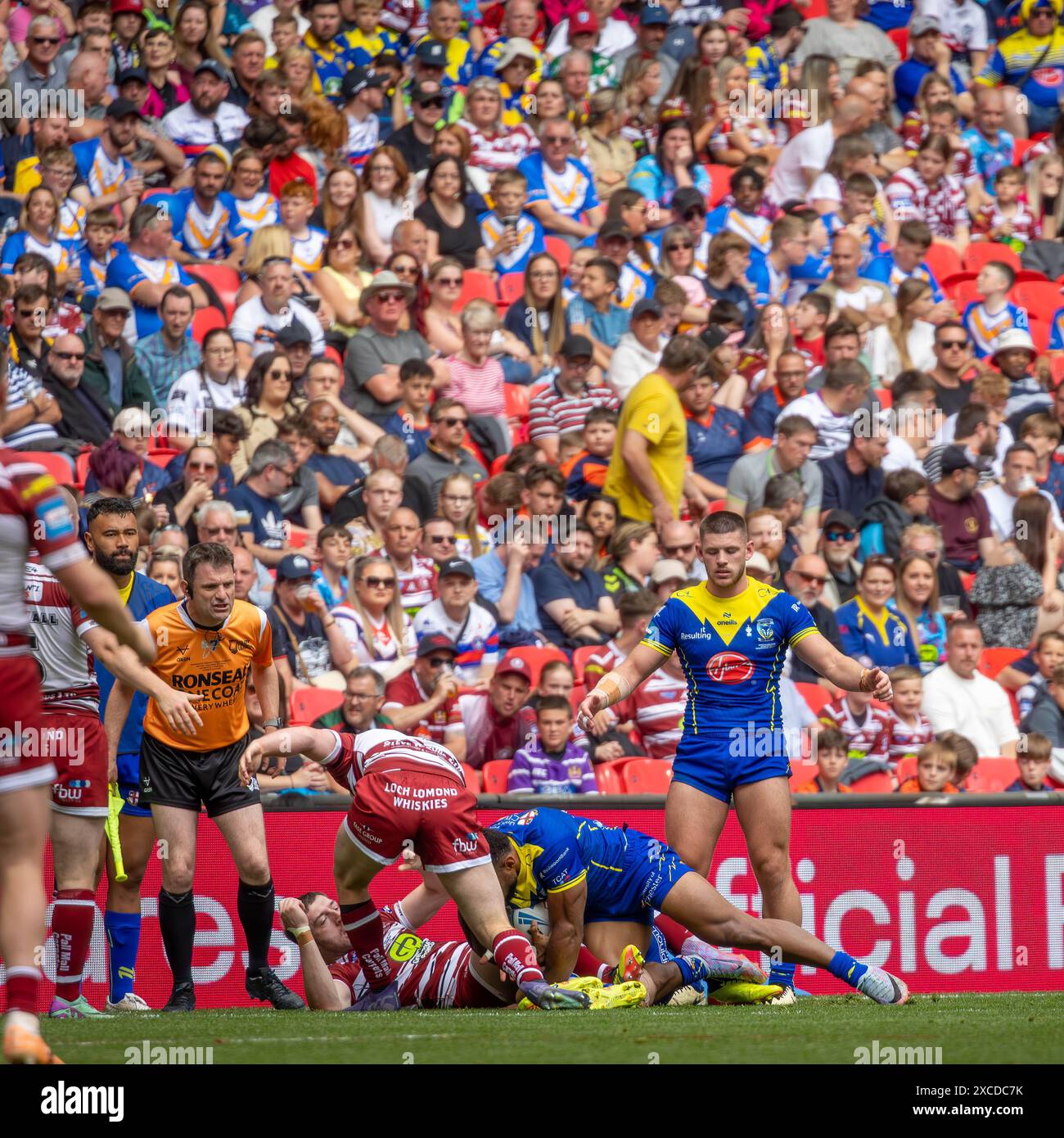 The 2024 Betfred Challenge Cup Final. Rodrick Tai is brought to the ground by Jake Wardle and Harry Smith as Danny Walker looks on Stock Photo