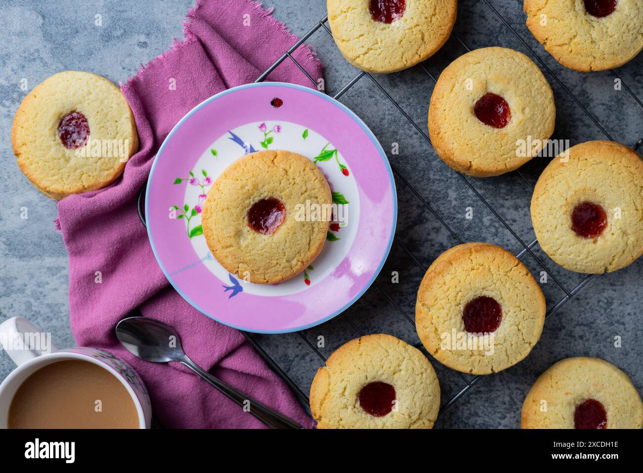 Tea and jam bscuits on pink plate Stock Photo