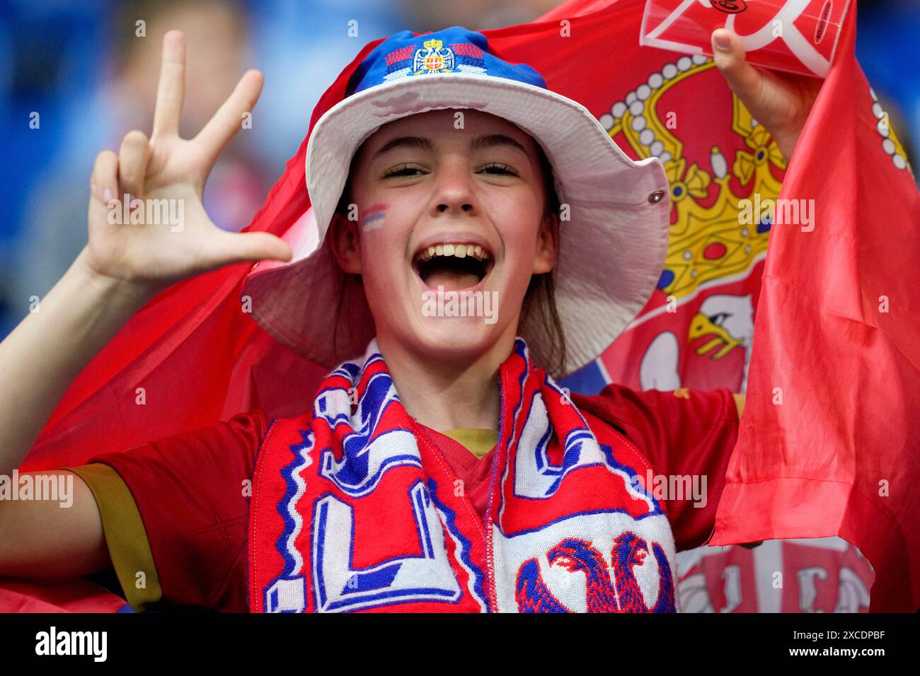 A fan flashes the Serbian three finger salute ahead of a Group C match